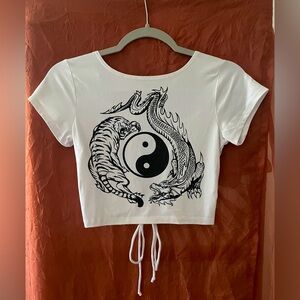 Unknown brand. Size small open backed cropped shirt. Like new.